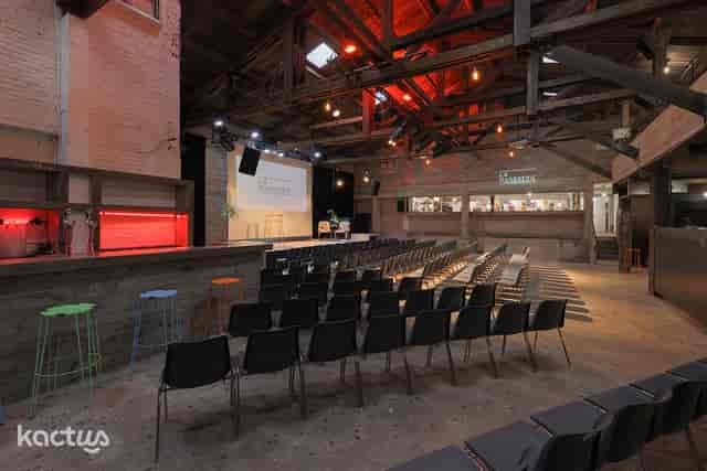 LA GRANDE SALLE at La Marbrerie, rustic event space with flexible seating for gatherings.