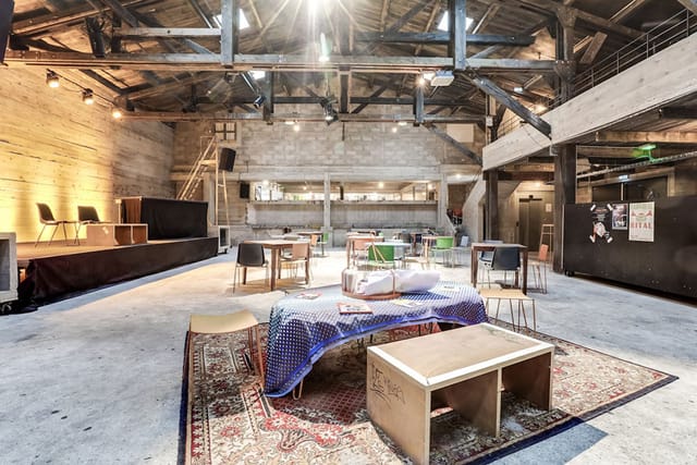 Versatile event space with rustic charm, ideal for gatherings and presentations at La Marbrerie.