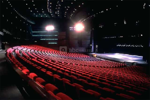 Spacious auditorium with tiered red seating for conferences at Palais des Congrès de Paris.