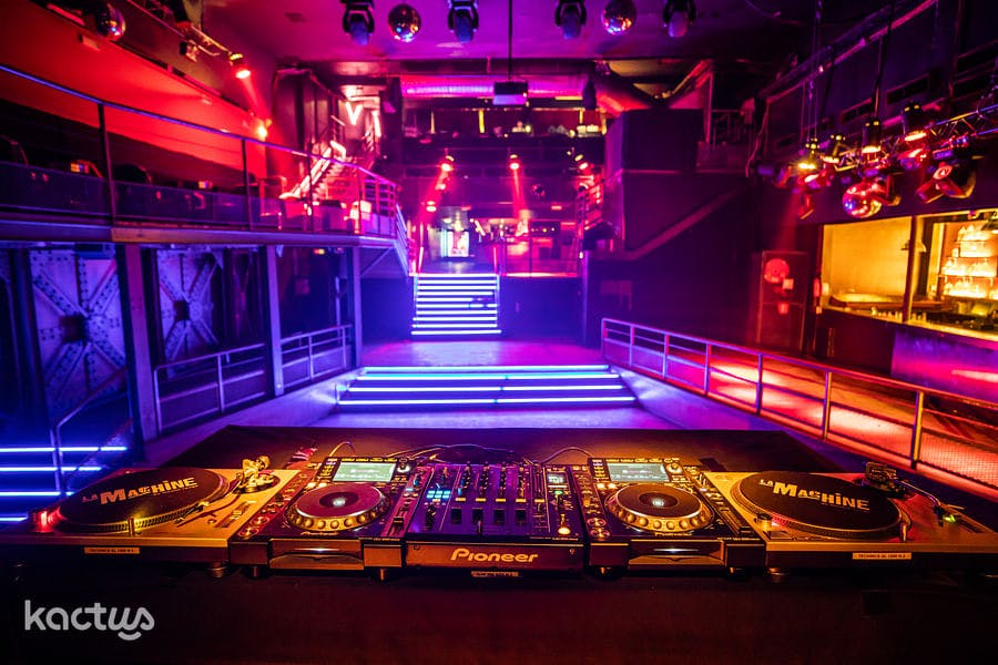 Vibrant La Chaufferie event space with DJ booth for nightlife and corporate parties.