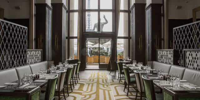 Private dining room at Café de l'Homme with elegant tables for events and gatherings.