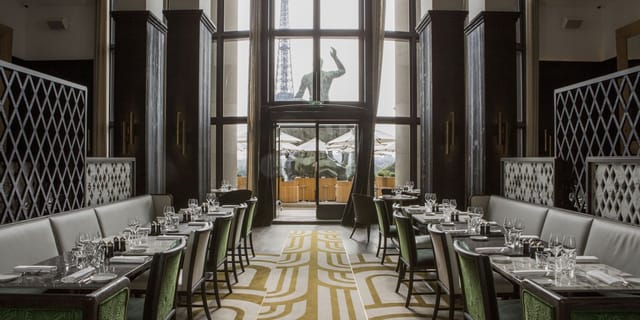Private dining room at Café de l'Homme with elegant tables for events and gatherings.