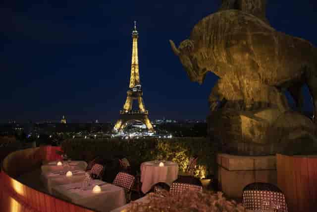 Elegant rooftop dining at Café de l'Homme with Eiffel Tower views, perfect for events.