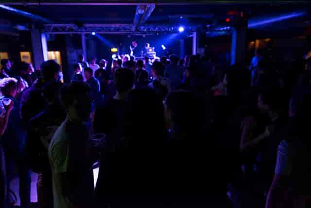 Vibrant crowd at Le Club, La Bellevilloise, ideal for social events and networking.