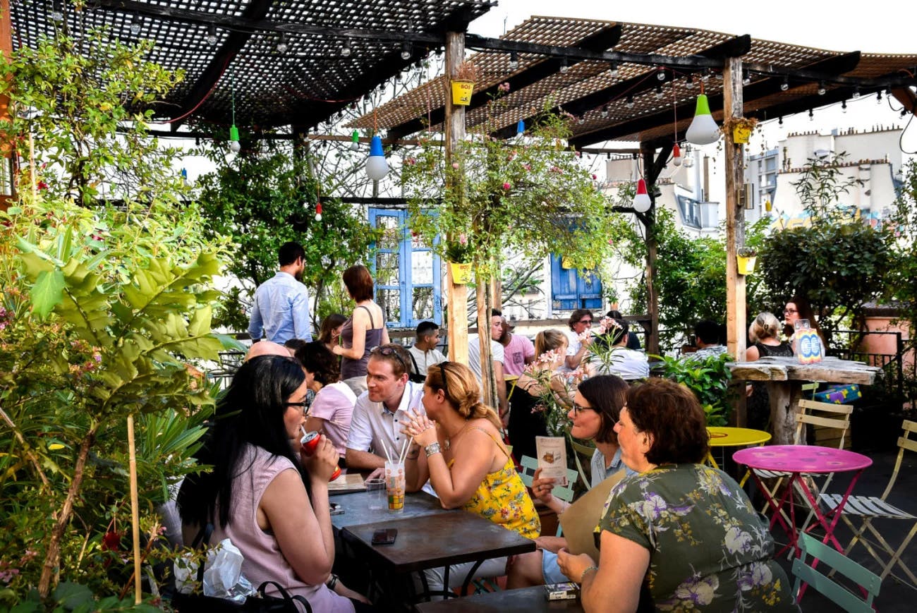 Vibrant La Terrasse outdoor venue with lush greenery for casual meetings and social events.