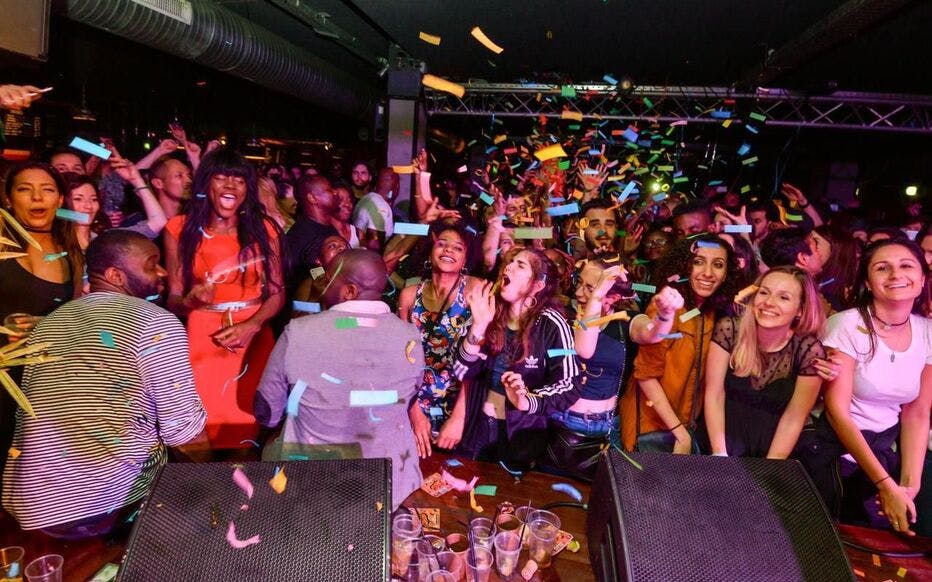 Vibrant nightclub event at La Bellevilloise with colorful confetti and lively crowd.