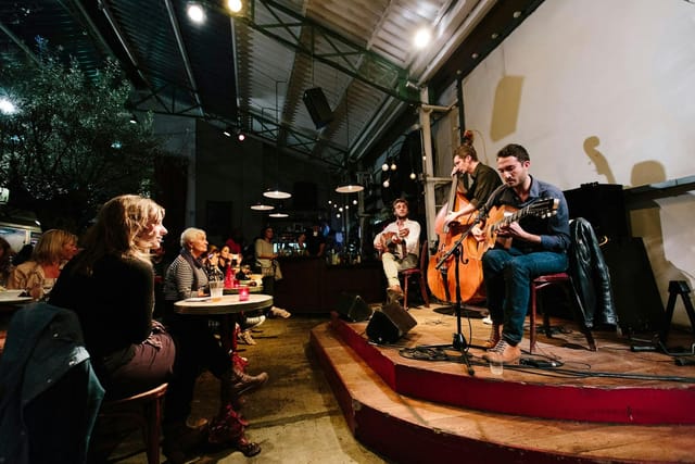 Vibrant live music night club at La Bellevilloise with warm lighting and casual seating.