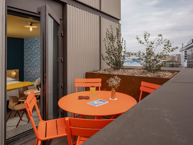 Vibrant outdoor terrace with orange furniture for networking events and casual receptions.