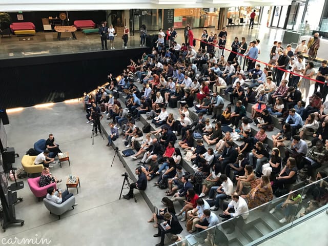 Master Stage at STATION F during a panel discussion with engaged audience and colorful seating.