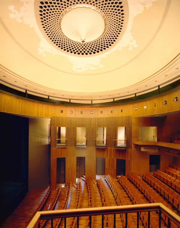 Elegant theater venue with high ceiling, perfect for conferences and corporate events.