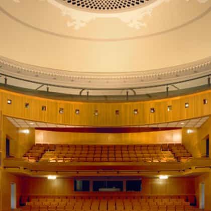 Spacious wooden auditorium at Cité internationale universitaire de Paris for conferences and presentations.