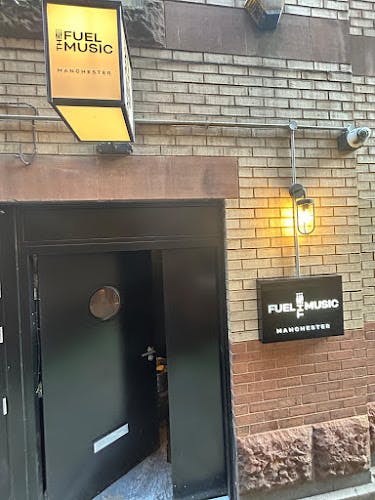 Open Mic Night at Fuel The Music venue with warm lighting and industrial decor.