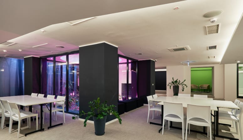 Modern event space with sleek furniture, ideal for meetings and social gatherings.