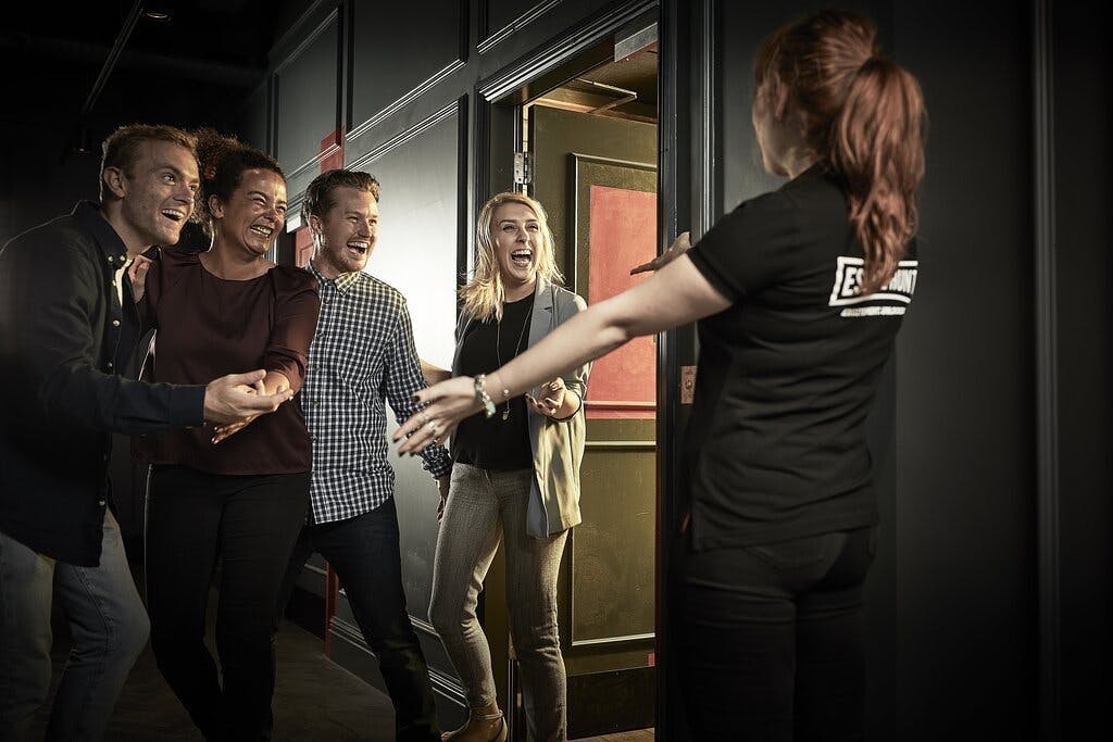 "Attendees welcoming staff at Alice in Puzzleland, Escape Hunt London event."