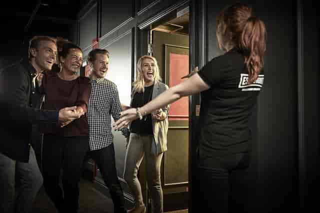 "Attendees welcoming staff at Alice in Puzzleland, Escape Hunt London event."