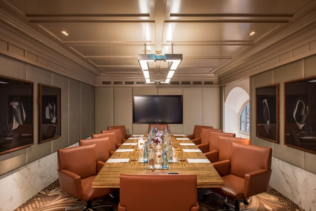 Elegant boardroom with leather chairs, perfect for corporate meetings and executive retreats.