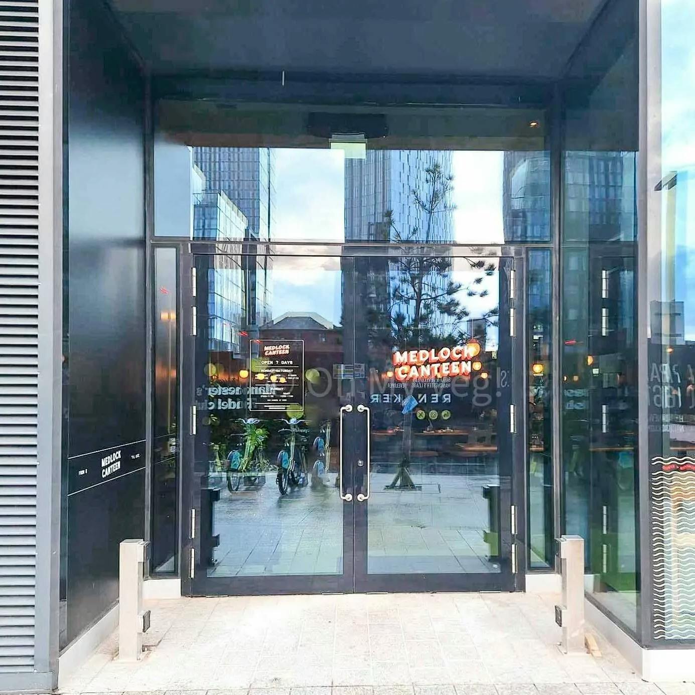Modern restaurant entrance with glass doors, ideal for casual meetings and events.