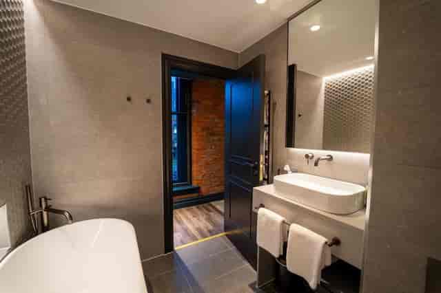 Modern boardroom bathroom with sleek fixtures for upscale meetings and conferences.