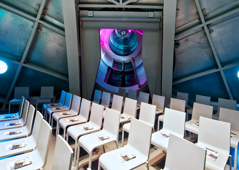 Prigogine event space in Atomium with white chairs for presentations and workshops.