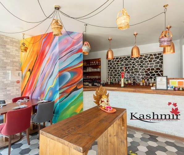 Private dining room in Kashmir with vibrant mural, perfect for networking events.