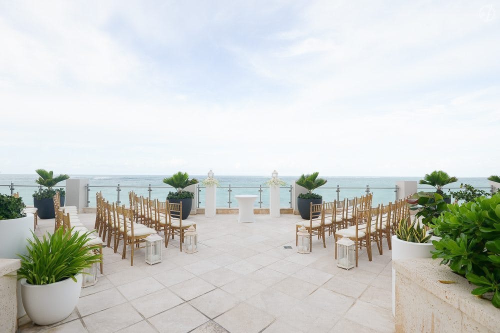 West Veranda at Condado Vanderbilt Hotel, elegant gold chairs for oceanfront weddings.