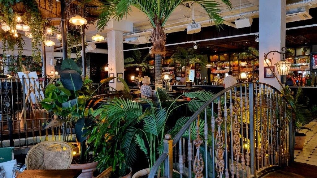 Vibrant restaurant venue with lush greenery for events in The Botanist Cardiff Central.