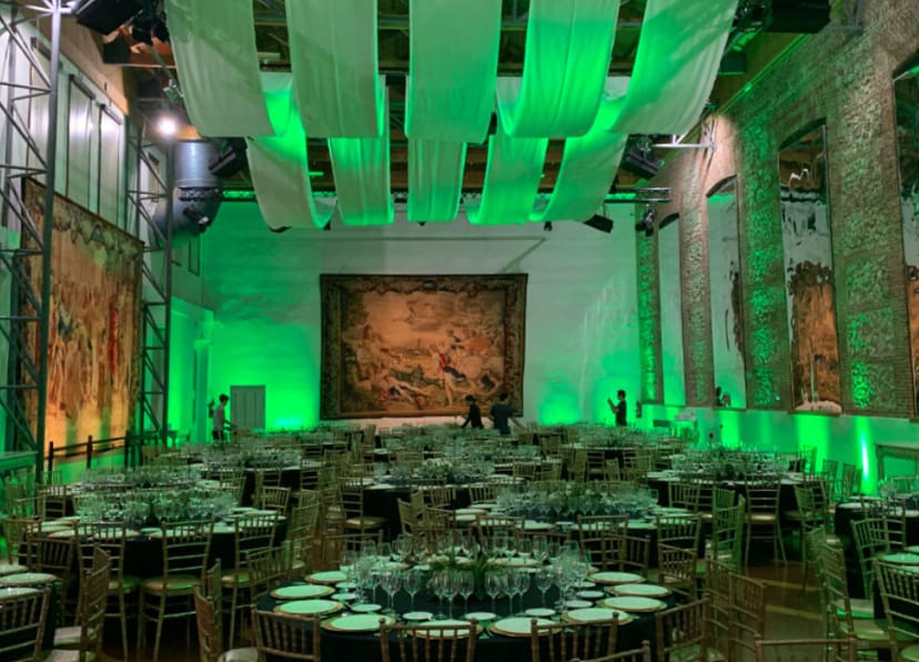 Elegant event space in Sala Goya with round tables and gold chiavari chairs.