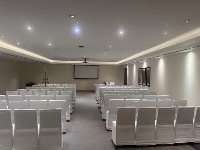 Abu Dhabi conference room with white chairs, ideal for professional meetings and presentations.