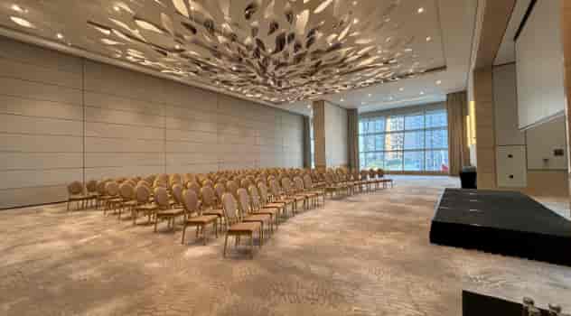 Astor 2 event space in St Regis Dubai with curved seating for corporate conferences.