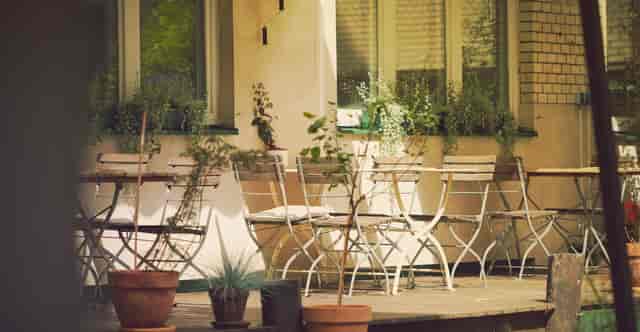 Charming outdoor office at Michelberger Hotel with rustic seating for casual meetings.