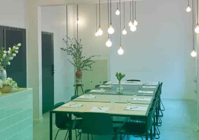 Modern meeting space at Michelberger Hotel with elegant table settings for workshops.