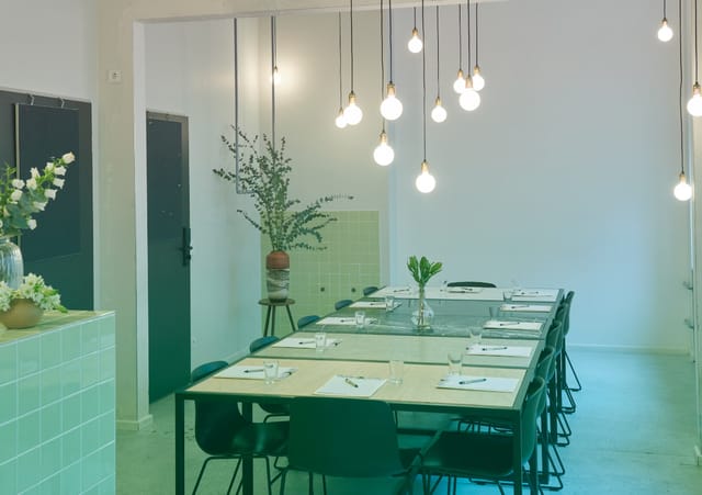 Modern meeting space at Michelberger Hotel with elegant table settings for workshops.
