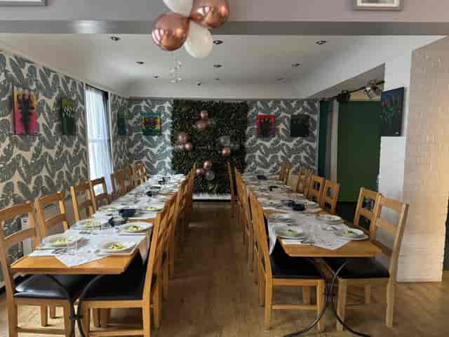 Elegant function room with long table, perfect for meetings and celebrations.