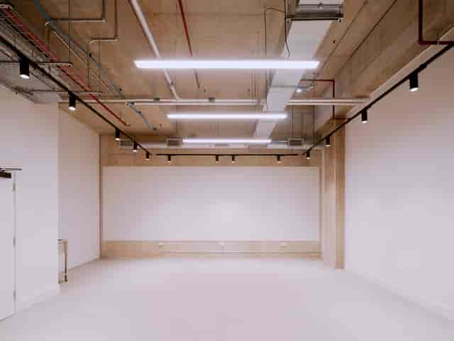 Versatile event space with natural light, ideal for workshops and presentations.