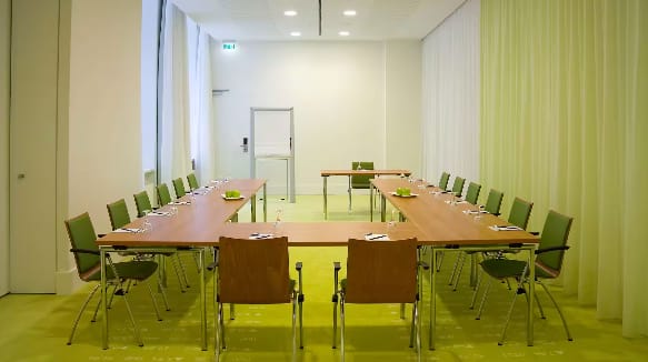 Modern meeting room at Nasdaq Berlin with long table, ideal for workshops and strategy sessions.