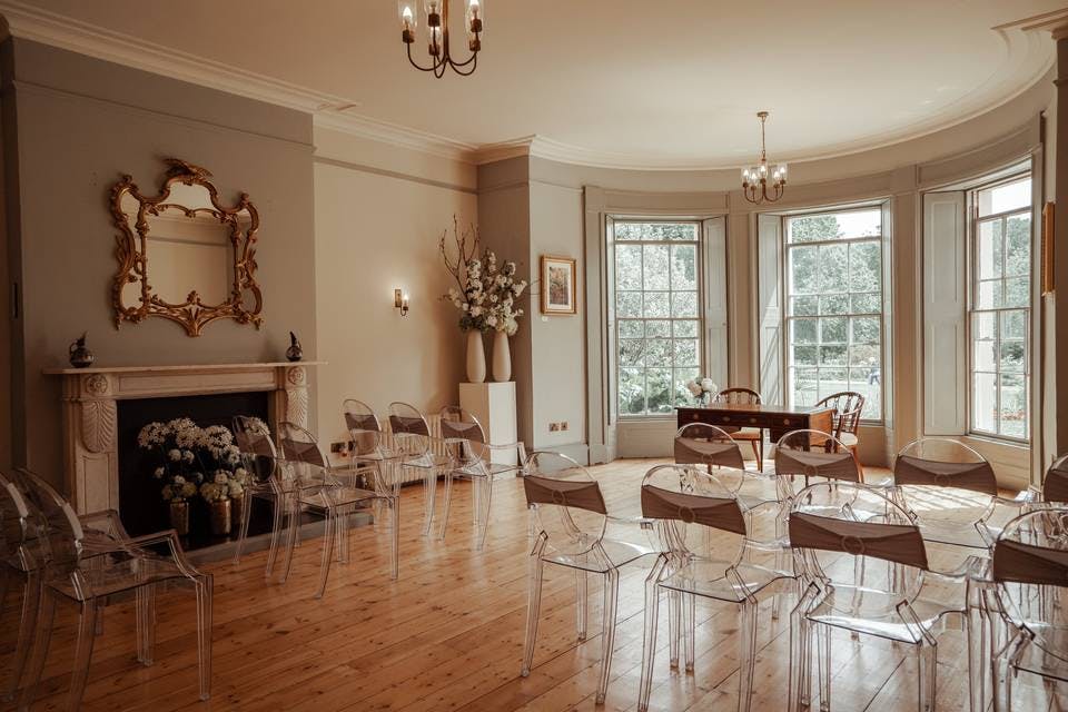 Elegant meeting space with transparent chairs for workshops and gatherings at Valentines Mansion.