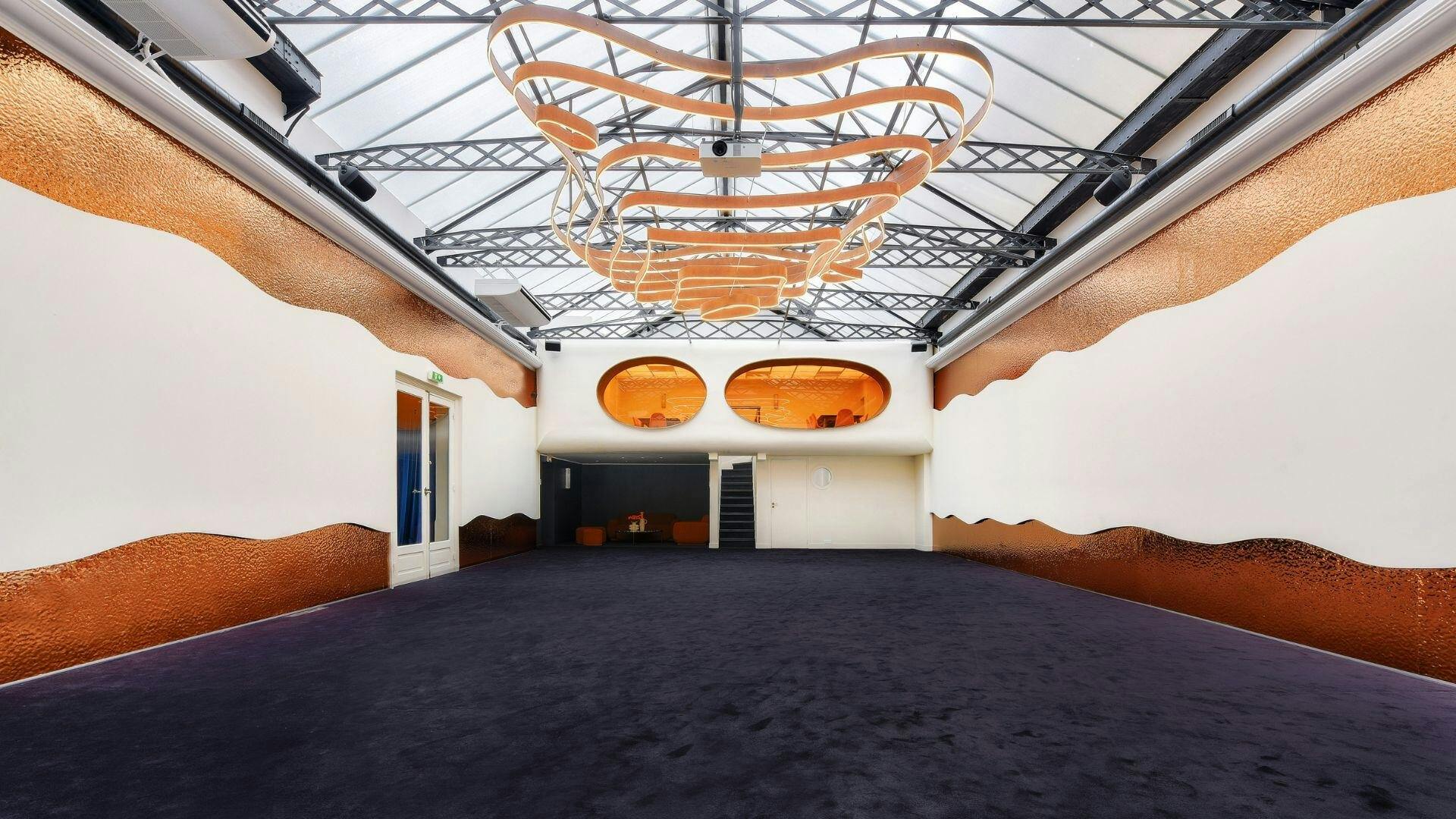 Modern Mezzanine event space with high ceiling, perfect for corporate meetings and social gatherings.