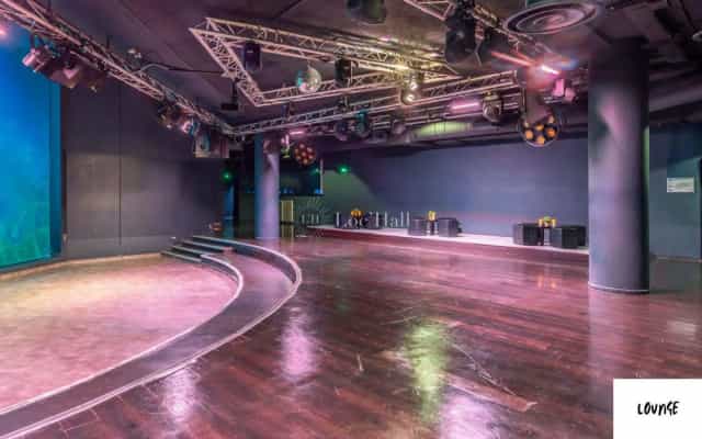 Modern event space with elevated stage at Aquarium de Paris for corporate and social events.