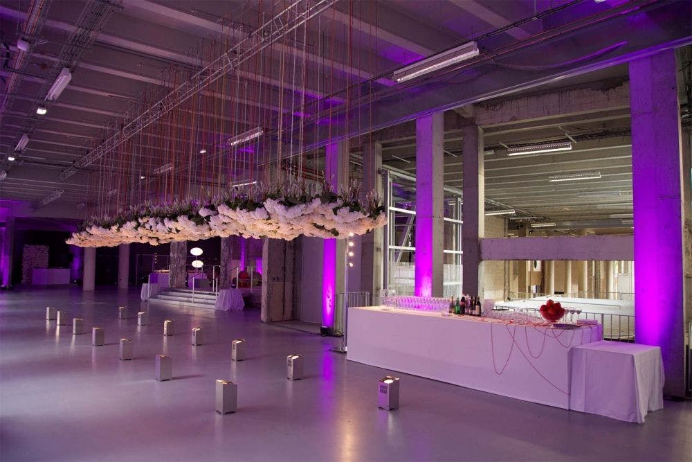 Elegant floral installation in modern event space at Palais de Tokyo for cocktail receptions.