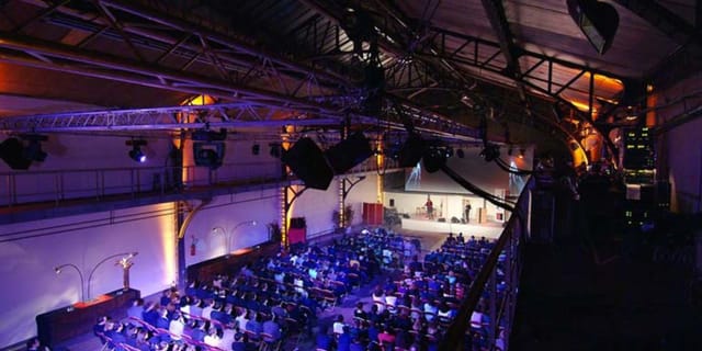 Event venue in Espace Clacquesin with audience, ideal for presentations and performances.