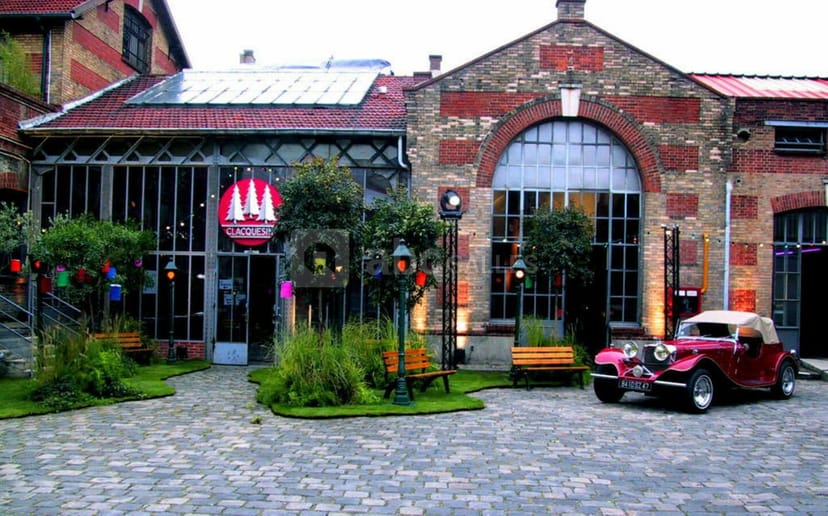 Charming event venue with rustic-modern architecture and vintage car for unique gatherings.