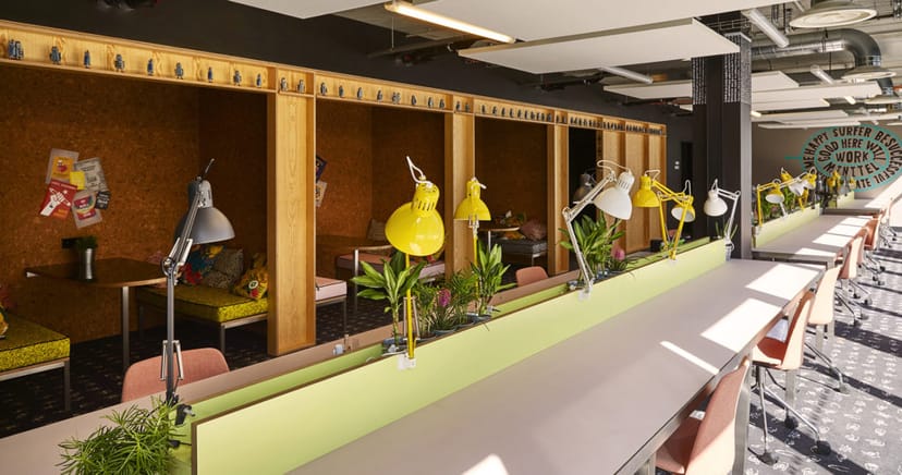 Modern coworking space with individual work pods for meetings and brainstorming.
