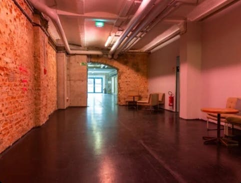 Spacious corridor with exposed brick in Factory Berlin Mitte, perfect for networking events.