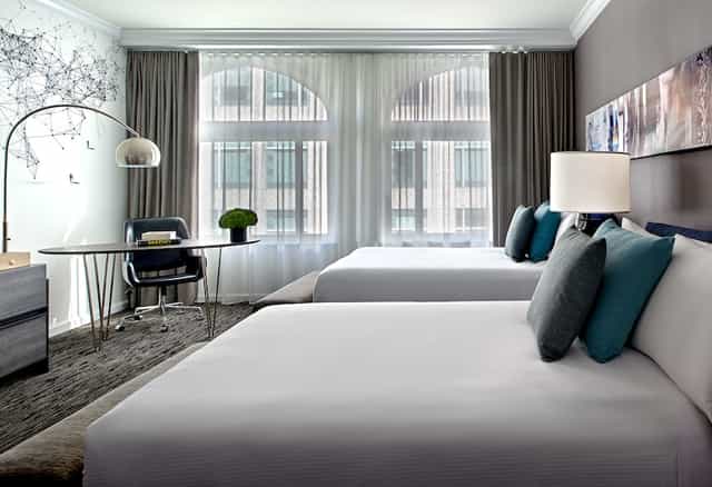 Modern hotel room at San Francisco Marriott Marquis with two beds, perfect for business events.