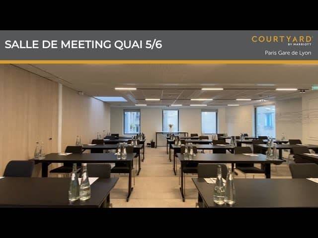 Modern meeting room with black tables for corporate workshops at Courtyard Paris Gare de Lyon.