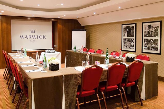 James Dean in a sophisticated meeting room with red chairs, ideal for professional events.
