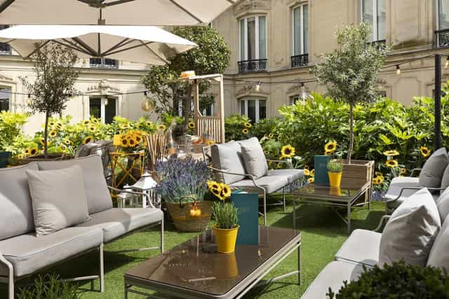 Outdoor event space at Fouquet's Paris with vibrant greenery for networking gatherings.