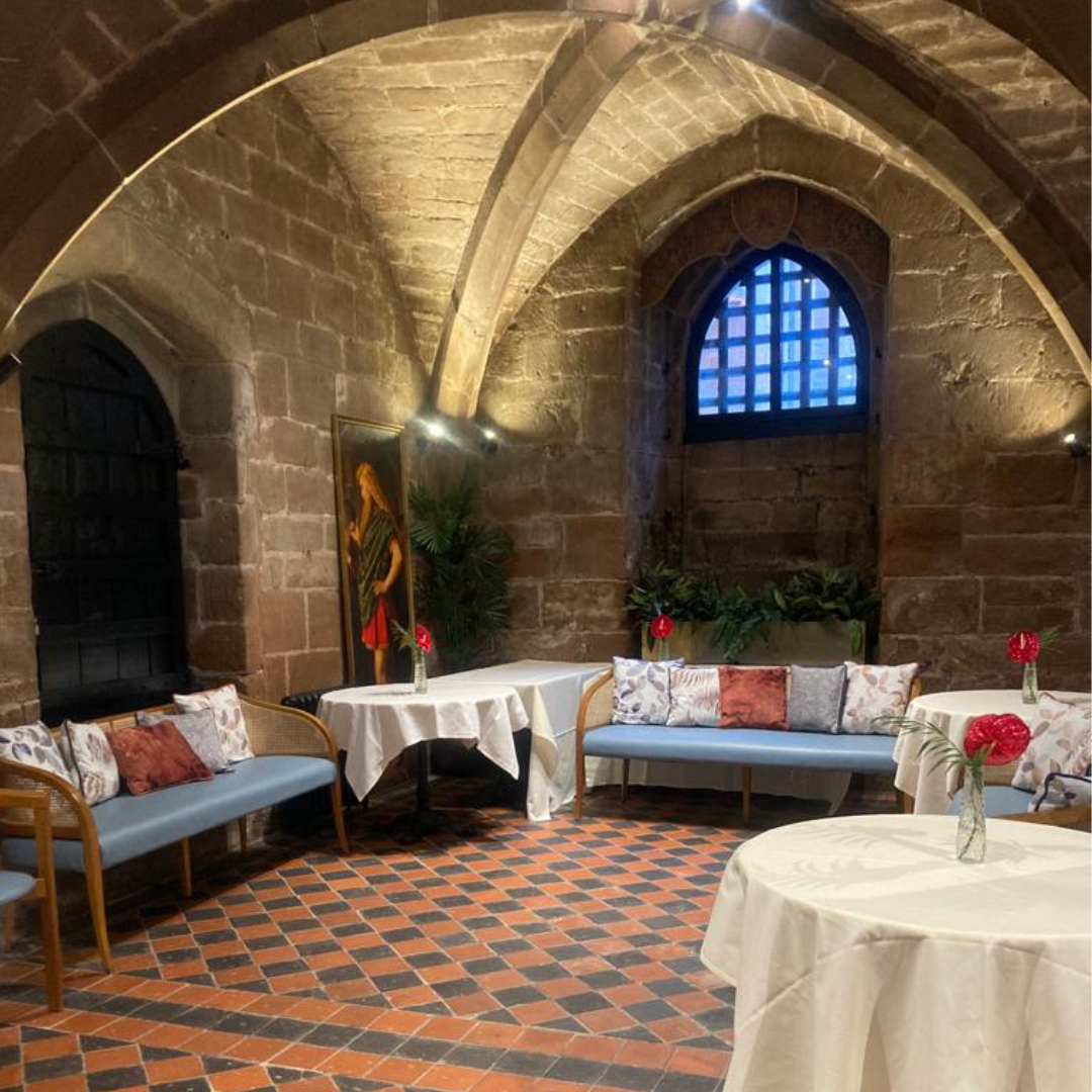 Intimate event space in St. Mary's Coventry with stone walls, ideal for gatherings and meetings.