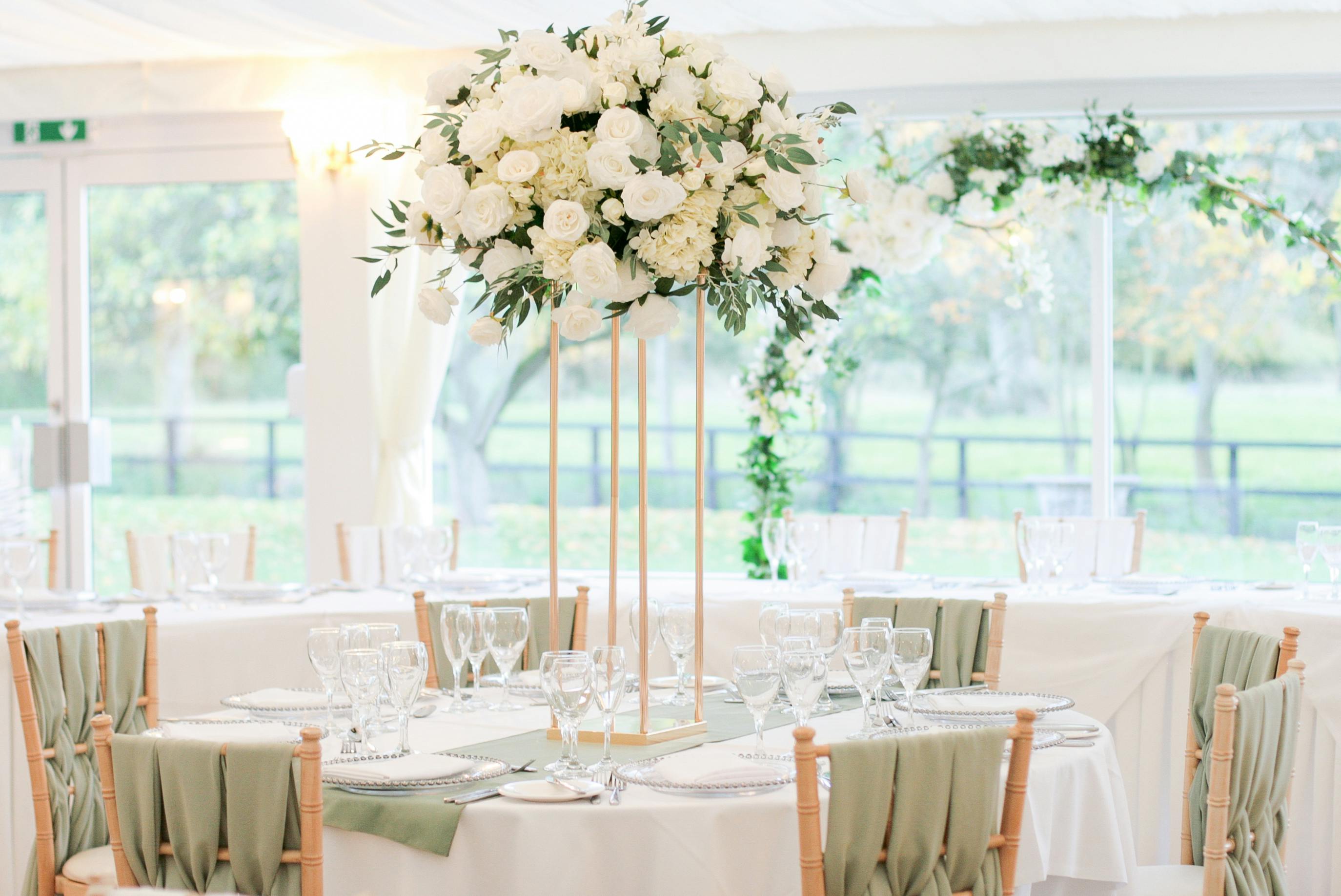 Elegant reception room with floral centerpiece, perfect for weddings and upscale events.