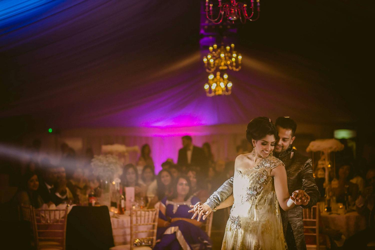 Banqueting Hall in Fennes, elegant wedding reception with soft lighting and chandeliers.